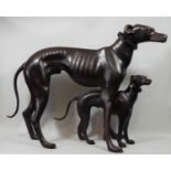 Contemporary bronze figure of a whippet in standing pose and further smaller example, 48 cm in
