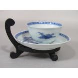 An 18th century oriental blue and white tea bowl and saucer from the Nanking Cargo, both pieces with