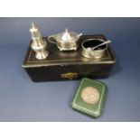 Cased silver three piece cruet set comprising salt, pepper and lidded mustard both with blue glass