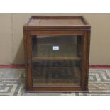 A small Edwardian oak counter top display cabinet of square cut form with glazed panelled surround
