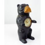 A carved softwood figure of a Bulldog in standing pose, to his body a small time piece, 22cm high