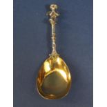 Good quality Victorian silver caddy spoon mounted by a cast seated cherub with gilt bowl, maker