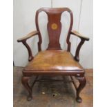 A Georgian mahogany elbow chair with shaped arms and vase shaped splat inlaid detail raised on