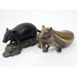 A Japanese bronze figure of a rat hauling a heavy sack, and a further rat standing of a pile on