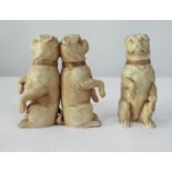 Three late 19th century German bisque figures of Bulldogs in upright pose, two back to back,