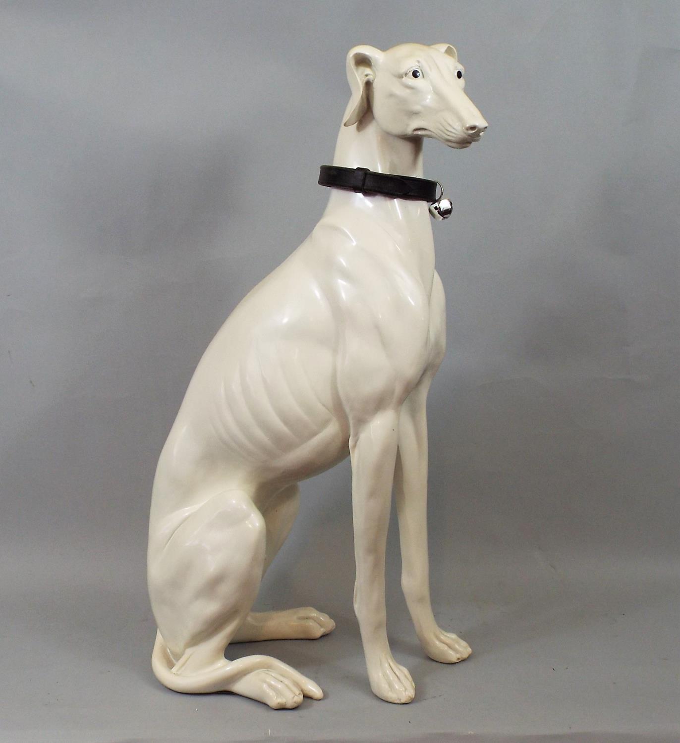 A resin figure of a seated Whippet, 53 cm