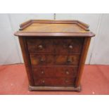 A small walnut and figured walnut Wellington chest of four drawers with central locking mechanism,