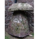 A weathered rough hewn staddle stone and thick domed cap 60 cm in diameter x 82 cm high approx