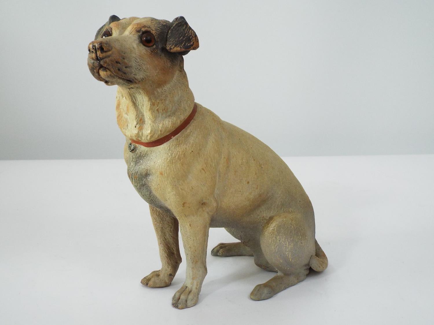 A late 19th century terracotta model of a seated terrier with naturalistic painted detail, 22cm high