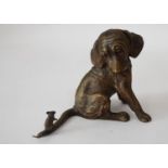 A bronze model of a puppy, confused by a small mouse, perched on the tip of its tail, 7cm high