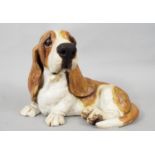 A studio pottery figure of a seated Basset Hound by Joanna Cooke, 15cm approx