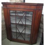 A 19th century mahogany hanging corner cabinet with inlaid detail enclosed by an astragal glazed