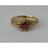 Claw set ruby solitaire ring in unmarked yellow metal with scrolled shoulders, size N, 4g