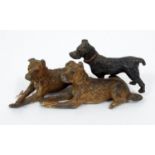 A small painted lead group of three entwined hounds, 7 cm in length