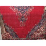 Kashan carpet with central blue floral medallion upon a red ground, 380 x 240cm