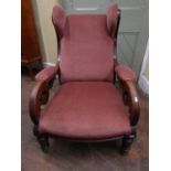 A late regency mahogany framed library of drawing room chair with carved show wood frame, with