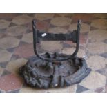 A cast iron boot scraper with oval scrolling acanthus tray