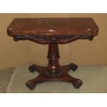 A William IV rosewood veneered fold over top card table of rectangular form with rounded front