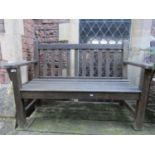 A Barlow Tyrie stained teak, two seat garden bench with slatted seat and back, 132 cm wide