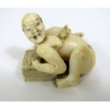 Meiji Period - Ivory Okimono of a man in a loin cloth spooked by a rat upon his back, signed, 4cm