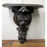 19th century carved oak bracket with lion mask and fruit detail, 60cm high