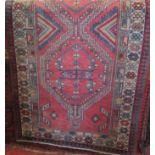 A good old Persian runner with various geometric medallion decoration upon a washed red ground,
