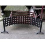 A cast iron fire basket with concave trellis front together with one other (AF)