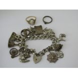 Mixed lot comprising a 9ct cameo ring, silver curb link charm bracelet hung with charms to include a