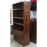 A contemporary Chinese hardwood freestanding side cupboard/shelving unit with moulded outline and
