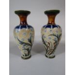 A pair of Doulton Lambeth stoneware vases of shouldered form with incised and painted organic and