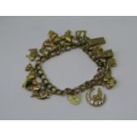 9ct double curb link charm bracelet with heart padlock clasp, hung with eighteen novelty charms,