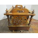 A Victorian walnut three divisional Canterbury of usual form over a single frieze drawer