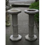 A pair of contemporary two sectional cast composition stone bird baths of octagonal form with fluted