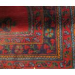 Turkish carpet with blue and green medallions upon a red ground, 320 x 250cm