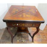 A Victorian rosewood envelope card table of usual form, over a frieze drawer on shaped supports with