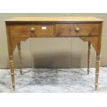 A 19th century pine two drawer side table raised on ring turned and tapered legs with shaped