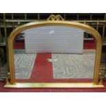 A contemporary Victorian style overmantle mirror with bevelled edge plate within a gilt arched and