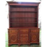 Early 19th century provincial breakfront dresser in mixed woods, the central tower of four drawers