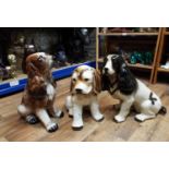 Three pottery figures of spaniels, 40 cm and smaller