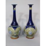 A pair of Doulton Lambeth blue ground vases of bottle shaped form with classical style medallion