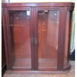 A Victorian mahogany shop display cabinet rectangular with a single D shaped end enclosed by three