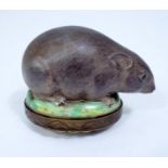 An early 19th century continental porcelain box and cover mounted by a large black rat, the lid