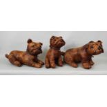 Three tan leather studies of dogs or puppies in the form of Bulldogs in various poses, 28cm max