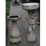 A contemporary slightly weathered cast composition stone bird bath in the form of a standing