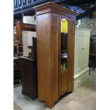 An Edwardian satin walnut single wardrobe with stepped and moulded cornice over a full length