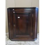 A Georgian oak hanging corner cupboard enclosed by rectangular panelled door, together with two 19th