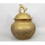 A 19th century Indian brass ware bowl and cover, the top surmounted by a dog quarrelling with a rat,
