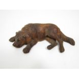 Late 19th century Austrian carved timber study of a resting hound, 18cm