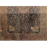 Kashan type carpet with scrolled foliate decoration upon a navy blue blue ground, 320 x 230cm (