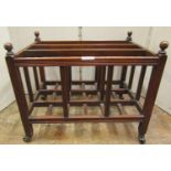 A simple Edwardian mahogany three divisional Canterbury, with reeded frame work on turned finials,